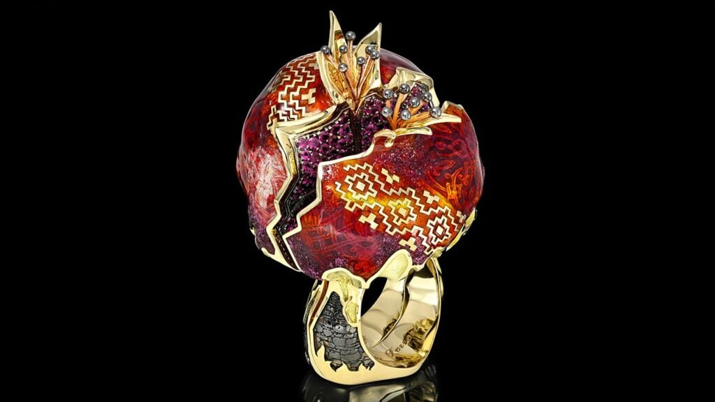 An 18-karat yellow gold ring featuring a pomegranate with enamel artwork and brilliant-cut red rubies, Jewelers of America image