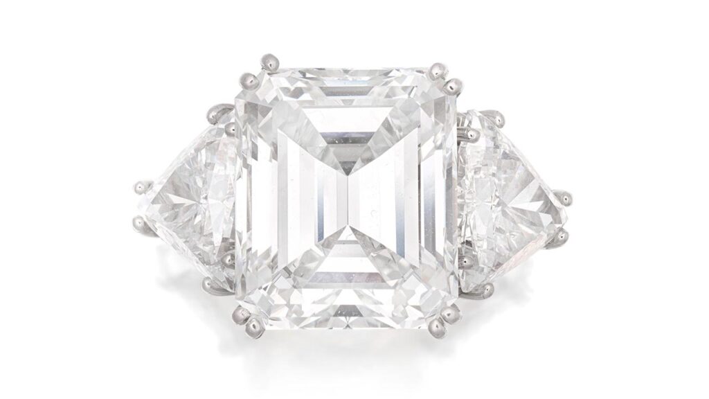 A ring centering a step-cut, 8.54-carat, VS1-clarity diamond with trilliant-cut diamond shoulders at Bonhams image