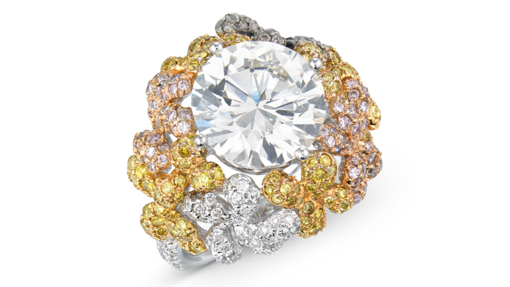 A round brilliant-cut, 5.45-carat, G, VVS2 diamond is the star of this ring. It has a surround of round, multicolored diamonds and white diamonds at Christie's image