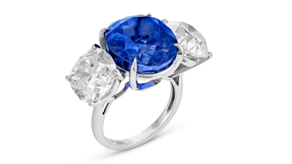 A ring centering an oval brilliant-cut, 20.54-carat Ceylon sapphire between two circular-cut diamonds weighing 4.63 and 5.11 carats at Christie's image