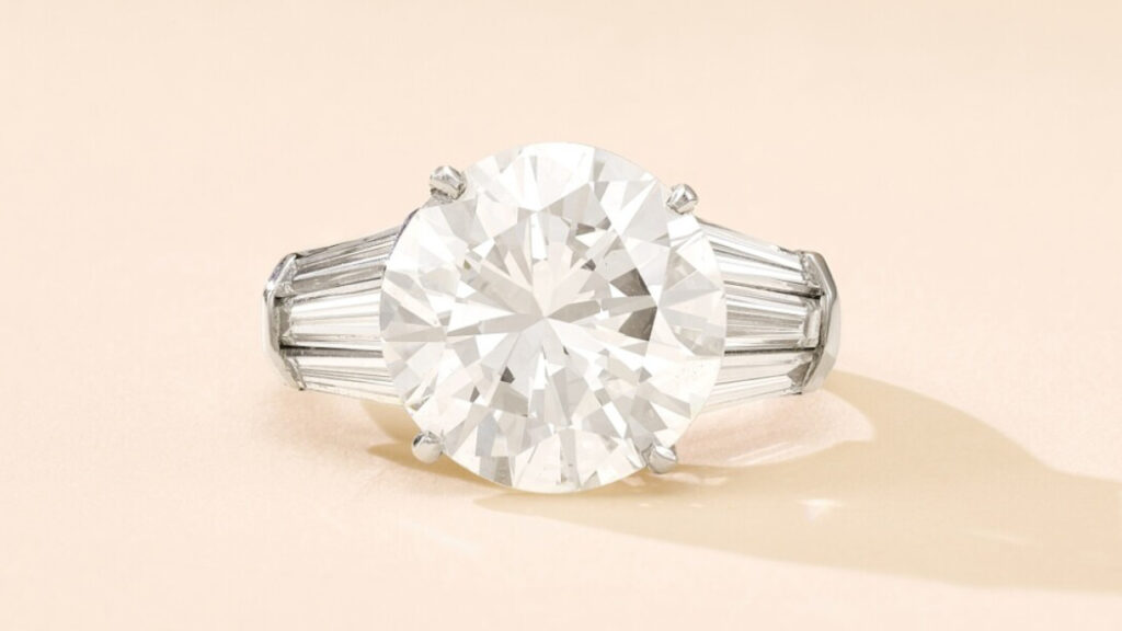 A ring bearing a brilliant-cut, 8.03-carat, G-color, VS2-clarity diamond between curved baguette shoulders at Sotheby's image