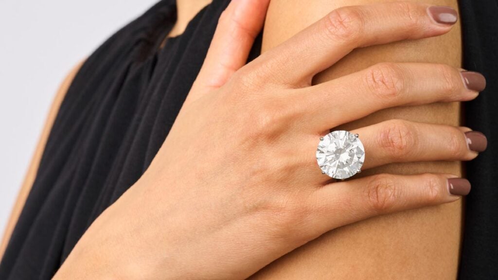 A model wearing a round brilliant-cut 26.36-carat diamond that sold at Elmwood’s image