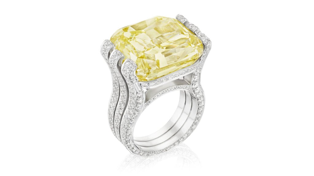 A ring featuring a cushion-cut, 30.20-carat, fancy-intense-yellow, VS2-clarity diamond within a round brilliant-cut diamond-set mount at Bonhams image