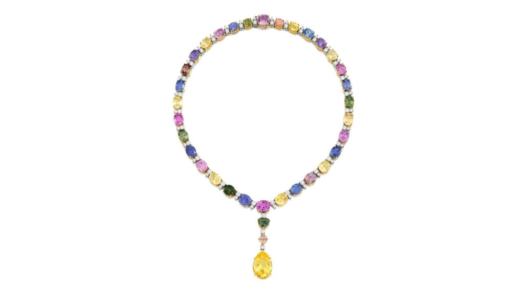 A Bulgari necklace comprising oval-shaped multicolored sapphires alternating with duos of round brilliant-cut diamonds. It centers a detachable pendant featuring a pear-shaped, 24.10-carat, yellow Ceylon sapphire at Bonhams image