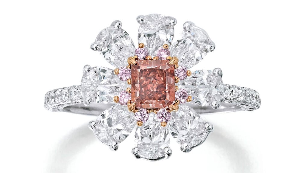 A ring with a radiant-cut, 0.53-carat, fancy-red, SI2 diamond, within a surround of pear-shaped and round brilliant-cut diamonds at Bonhams image
