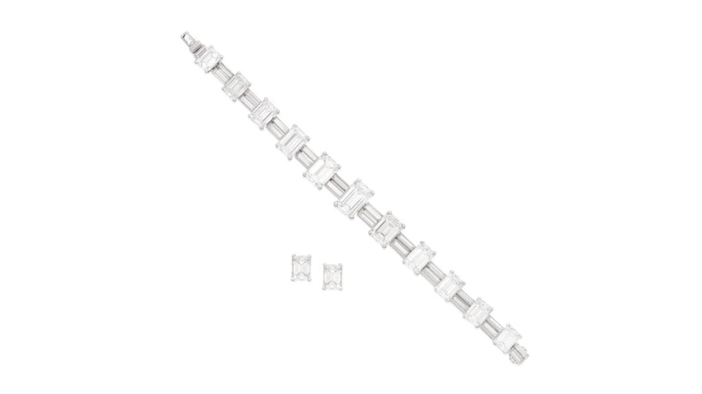 This Aldao set comprises a bracelet and a pair of ear studs. The bracelet has step-cut diamonds graduating in size toward the center, alternating between links with duos of baguette-cut diamonds. Each of the ear studs contains a step-cut diamond, weighing 1.45 and 1.50 carats at Bonhams image