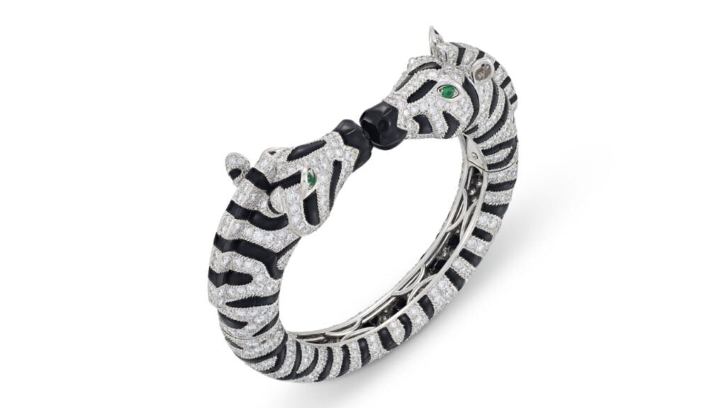 A Cartier bangle from the 1990s features two zebra heads comprising circular-cut diamonds, buff-top onyx cabochons and circular-cut emerald as eye at Christie's image