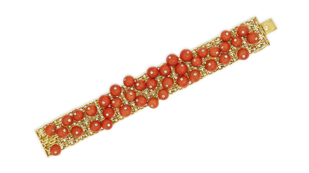 A Cartier gold bracelet with coral beads and single-cut diamonds at Christie's image