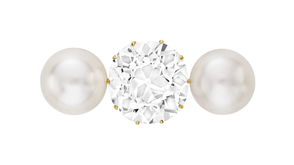 This brooch from around 1900 centers an old mine brilliant-cut, 18.27-carat, D, SI1 diamond between two button-shaped natural saltwater pearls at Christie's image