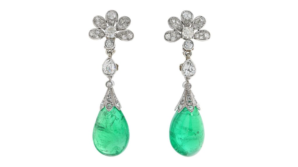 A pair of Chaumet earrings sporting two drop-shaped, Colombian emeralds with a total weight of around 40 carats, suspended from pear-shaped, old- and rose-cut diamonds at Christie's image