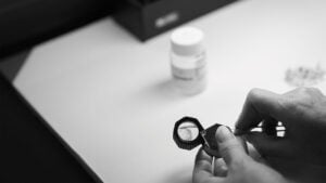A dealer evaluating OrigemA diamonds through a loop by Antwerp World Diamond Centre image