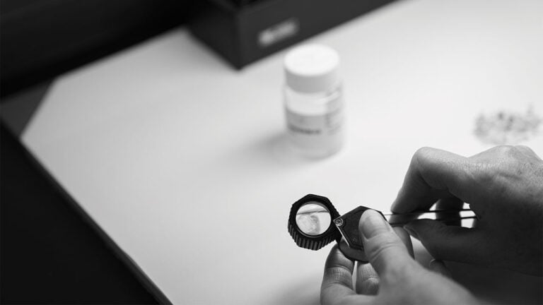A dealer evaluating OrigemA diamonds through a loop by Antwerp World Diamond Centre image