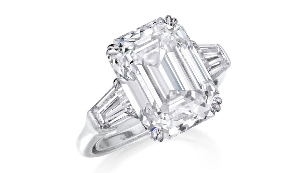A ring centering a step-cut, 7.30-carat, F-color, VS1 diamond flanked by two tapered baguette diamonds at Phillips image