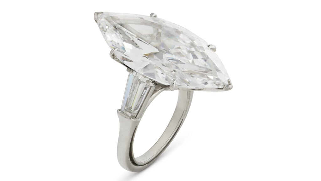 A Harry Winston ring bearing a marquise-shaped, 9.95-carat, D-color, VVS2-clarity diamond, between two trapeze-shaped diamonds at Christie's image