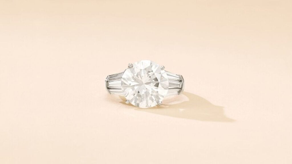 A ring with a brilliant-cut, 8.03-carat, G-color, VS2-clarity diamond and curved baguette shoulders at Sotheby's image