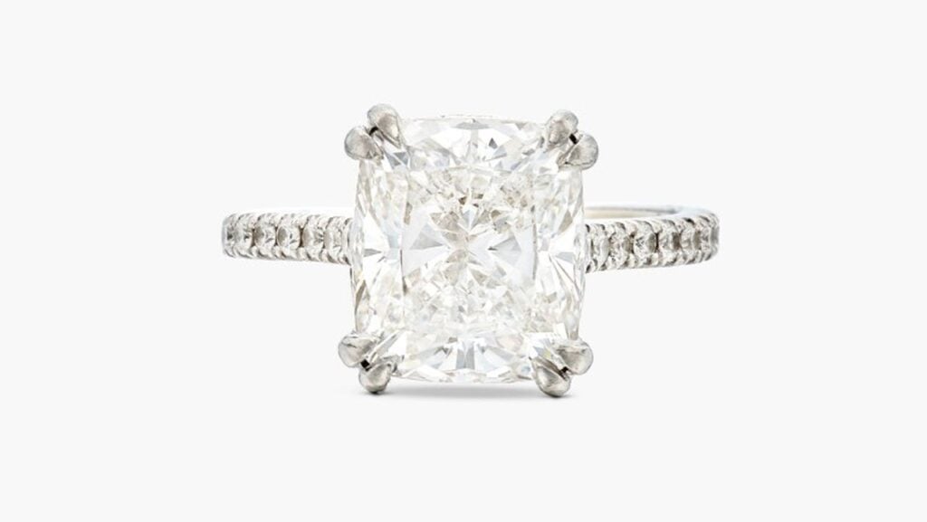 This ring features a cushion-cut, 5.01-carat, E, VS1 diamond with the shoulders enhanced by round diamonds at Sotheby's image