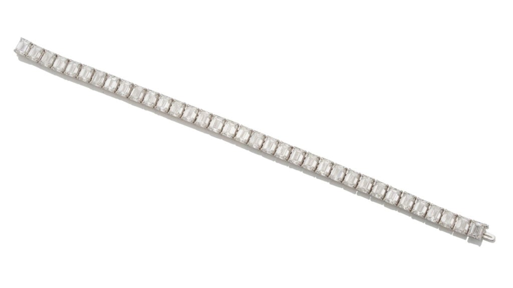 A bracelet comprising 35 emerald-cut diamonds totaling 24.61 carats, mounted in white gold at Bonhams image