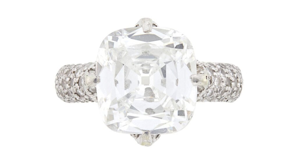 A JAR ring circa 1980 bears a cushion modified brilliant-cut, 5.78-carat, G, VS2 diamond with pavé-set round diamonds at Doyle image