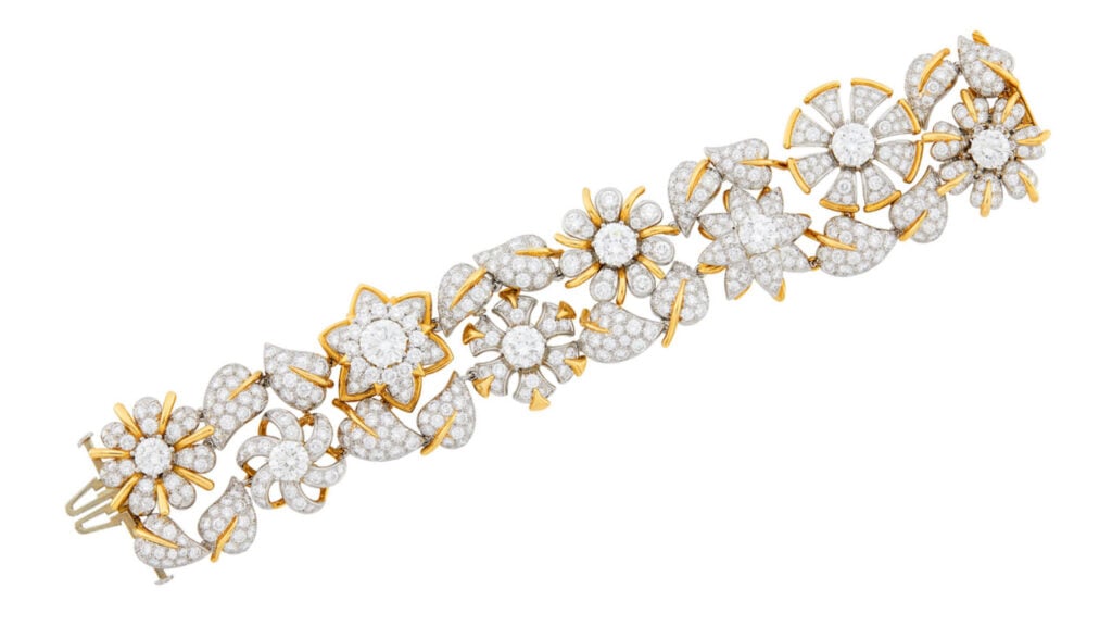 A Tiffany & Co. Fleurage bracelet is designed as flowers and leaves. Eight round diamonds, weighing a combined 10.80 carats, form the center of the flowers, while 439 small round diamonds, totaling 25 carats, adorn the petals and leaves at Doyle image