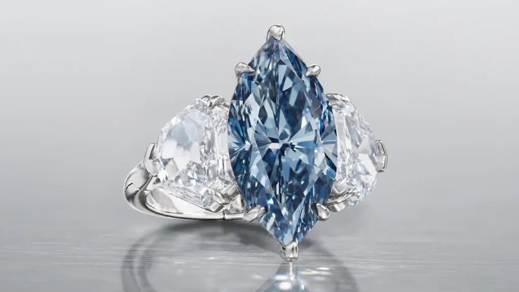 Ring, with a marquise brilliant-cut internally flawless center stone, flanked by trilliant-cut white diamonds at Christie’s image