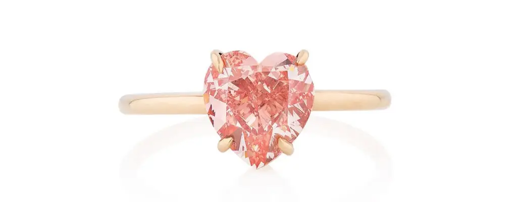 A heart-shaped, 1.85-carat, fancy-vivid-orangey-pink diamond ring at Phillips image