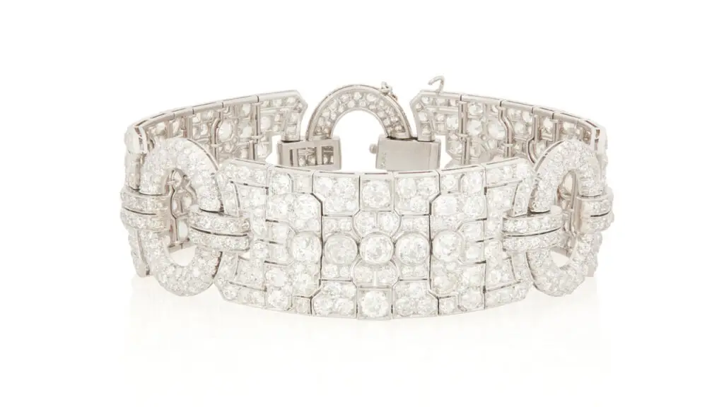 Raymond Yard designed this Art Deco diamond bracelet from around 1930. It features three ornate panels connected by oval circular frames with a total of 26 carats of old European- and old mine-cut diamonds at John Moran image