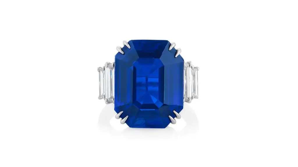 A ring bearing an octagonal step-cut, 18.09-carat Kashmir sapphire with diamond shoulders at Phillips image