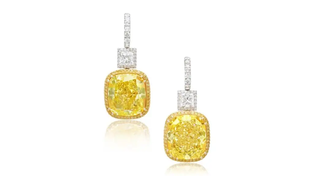 Scheiner designed these earrings sporting cushion modified brilliant-cut, fancy-vivid-yellow diamonds weighing 38.66 and 38.88 carats, suspended from rectangular modified brilliant-cut diamonds of 2 and 2.03 carats at Sotheby's image