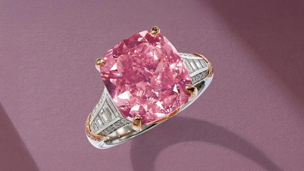 Glowing Rose — a cushion brilliant-cut, 10.08-carat, fancy-vivid-pink diamond mounted in a ring at Sotheby's image