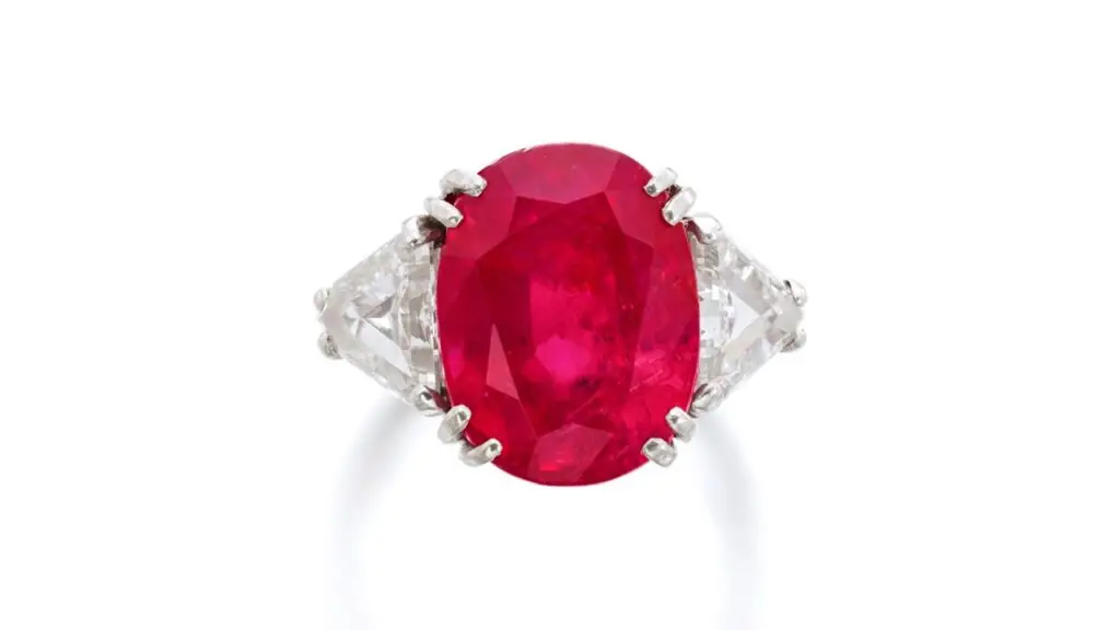 A ring with a cushion-shaped, 12.78-carat Burmese ruby between triangular diamonds at Sotheby's image