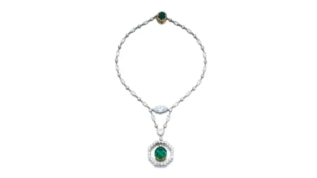 This Cartier necklace sports an octagonal step-cut, 11.78-carat Colombian emerald with an old mine-cut diamond surmount, swing-set within an old European-cut diamond frame. The necklace features a marquise-shaped, 5.54-carat, D-color, VS2 diamond at SOtheby's image