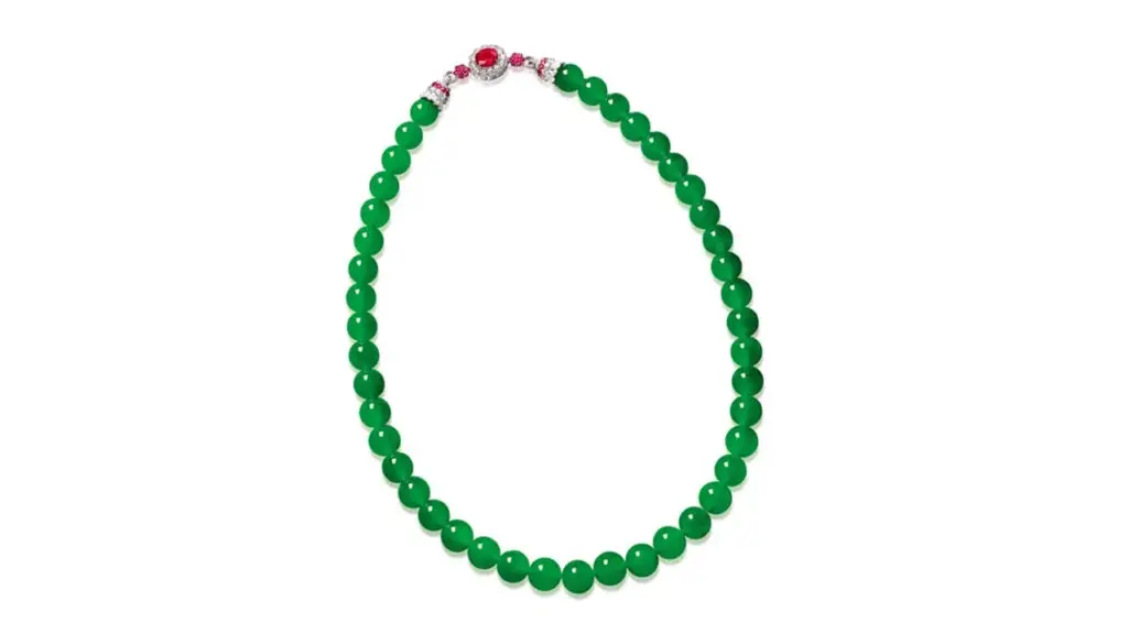 A jadeite necklace with a clasp featuring rubies and diamonds at Poly Auction image