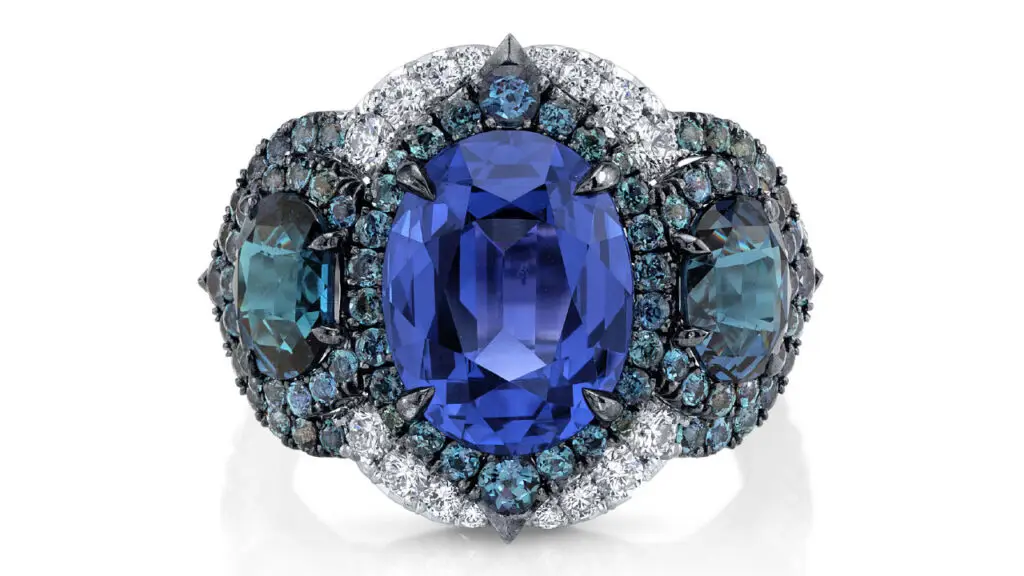 An Omi Privé ring featuring a color-change spinel between alexandrite and garnet side stones image