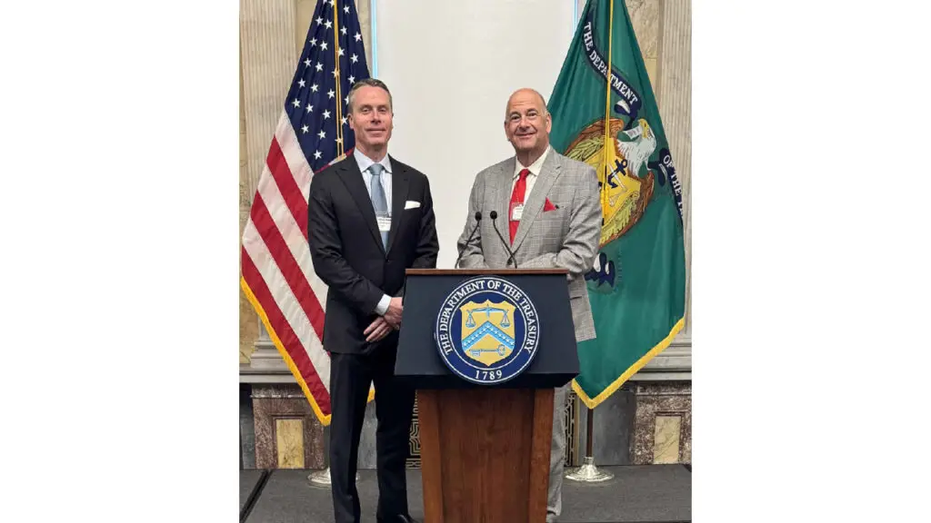 Bruce Bridges and John W Ford Sr at the briefing room podium in the Department of the Treasury image