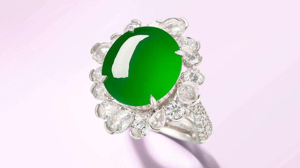 A ring bearing a green-hued Burmese jadeite, framed by 2.90 carats of diamonds at Bonhams image