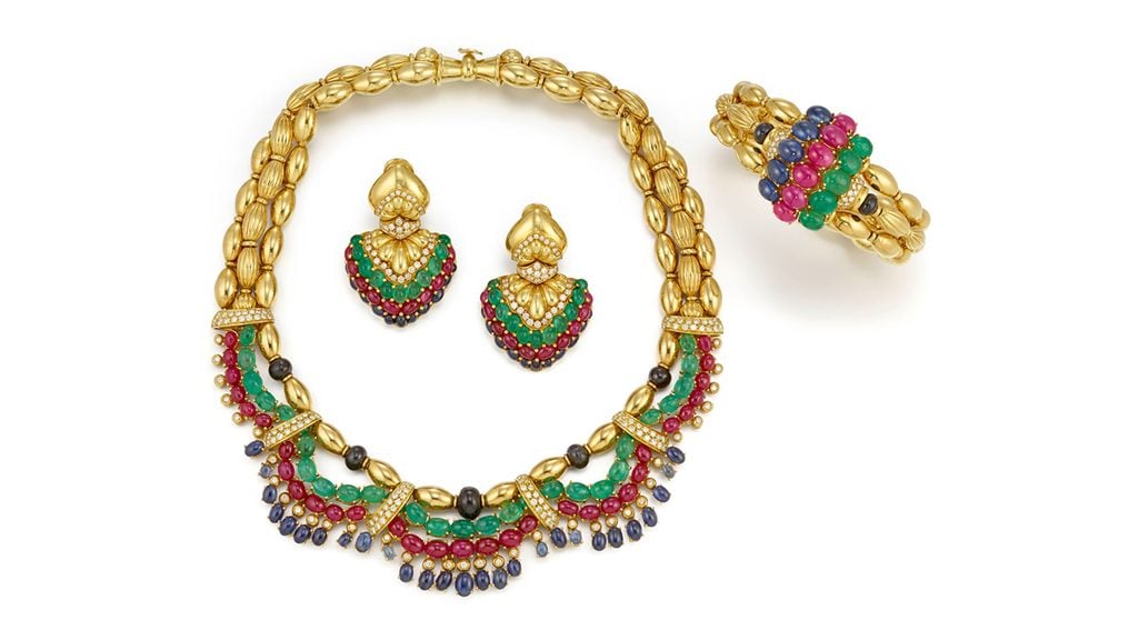 A gem and diamond set that includes a necklace, bracelet and earrings. In total, the pieces carry approximately 5.85 carats of diamonds, 36.85 carats of emeralds, 33.75 carats of rubies and 26.85 carats of sapphires at Bonhams image