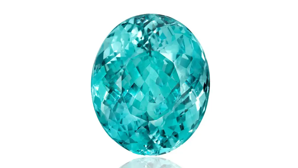 An unmounted oval-shaped, 30.61-carat Mozambique Paraíba-type tourmaline, accompanied by a hexagonal frame in a link necklace. The piece made six times its high estimate at Bonhams image