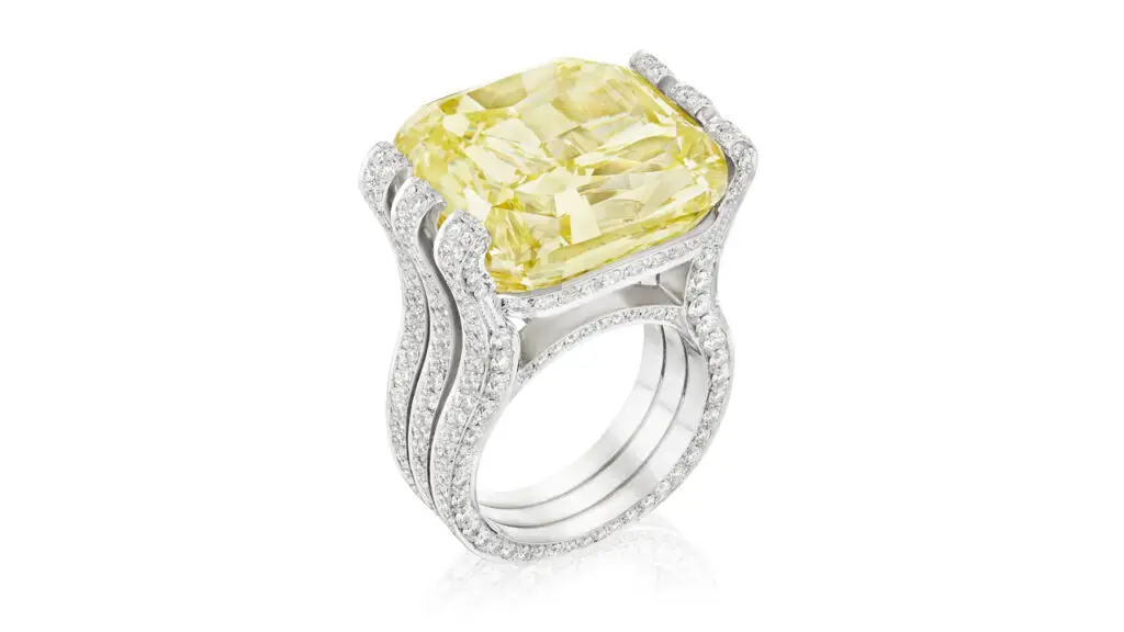 A ring featuring a cushion-cut, 30.20-carat, fancy-intense-yellow, VS2-clarity diamond within a round brilliant-cut diamond-set mount at Bonhams image