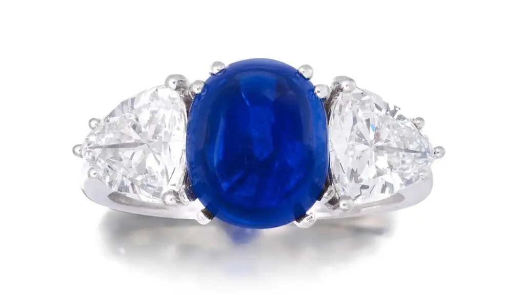 This ring stars a sugarloaf cabochon Kashmir sapphire weighing 5.63 carats and trilliant-cut diamond shoulders at Bonhams image