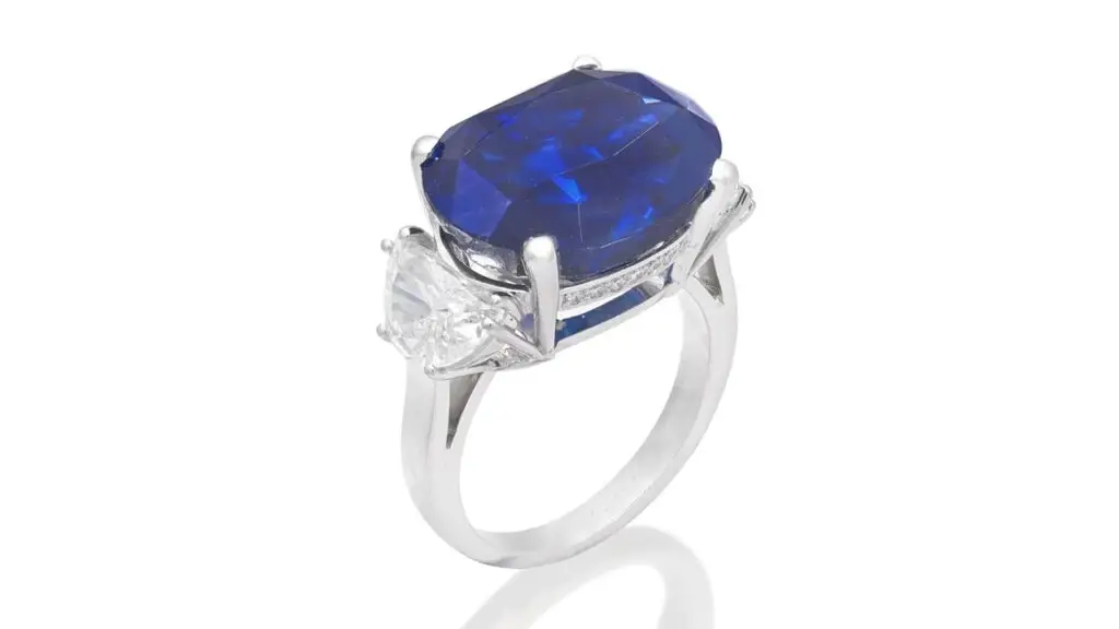An Aldao ring sporting an oval-cut,14.65-carat Burmese sapphire between demi-lune-cut diamond shoulders and a gallery pavé-set with brilliant-cut diamonds at Bonhams image