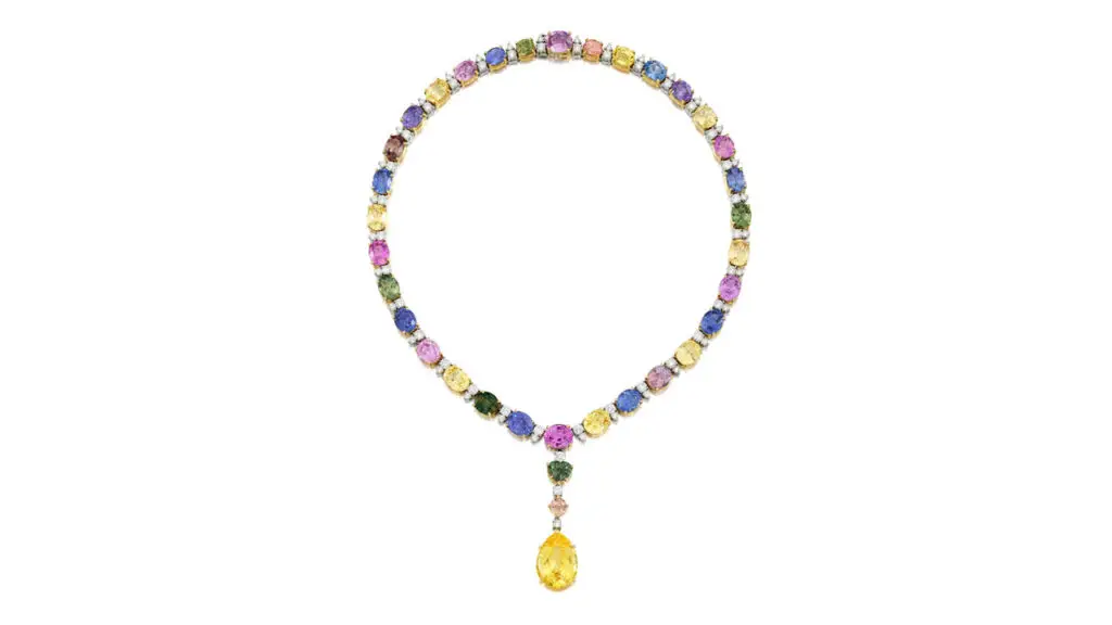A Bulgari necklace comprising oval-shaped multicolored sapphires alternating with duos of round brilliant-cut diamonds. It centers a detachable pendant featuring a pear-shaped, 24.10-carat, yellow Ceylon sapphire at Bonhams image