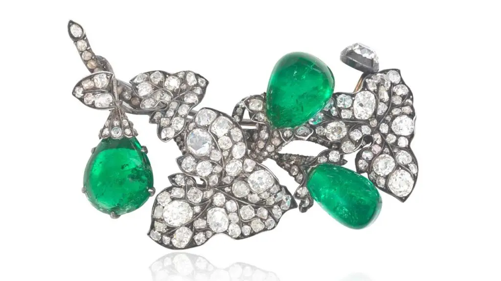 This brooch from around 1880 is designed as ivy leaves. It contains three pear-shaped Colombian emeralds, and is set throughout with old cushion, old brilliant and rose-cut diamond “buds” below rose-cut diamond surmounts. at Bonhams image