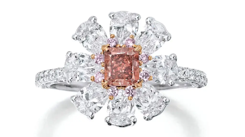 A ring with a radiant-cut, 0.53-carat, fancy-red, SI2 diamond, within a surround of pear-shaped and round brilliant-cut diamonds at Bonhams image