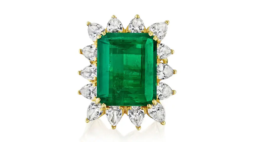 This ring centers an emerald-cut, 16.16-carat Colombian emerald with 14 pear-shaped diamonds framing it at Bonhams image