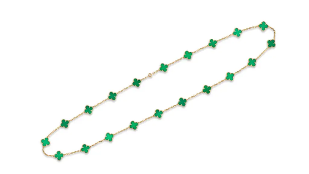 A Van Cleef & Arpels necklace composed of 20 chrysoprase quatrefoil motifs connected with a gold cable-link chain at Bonhams image