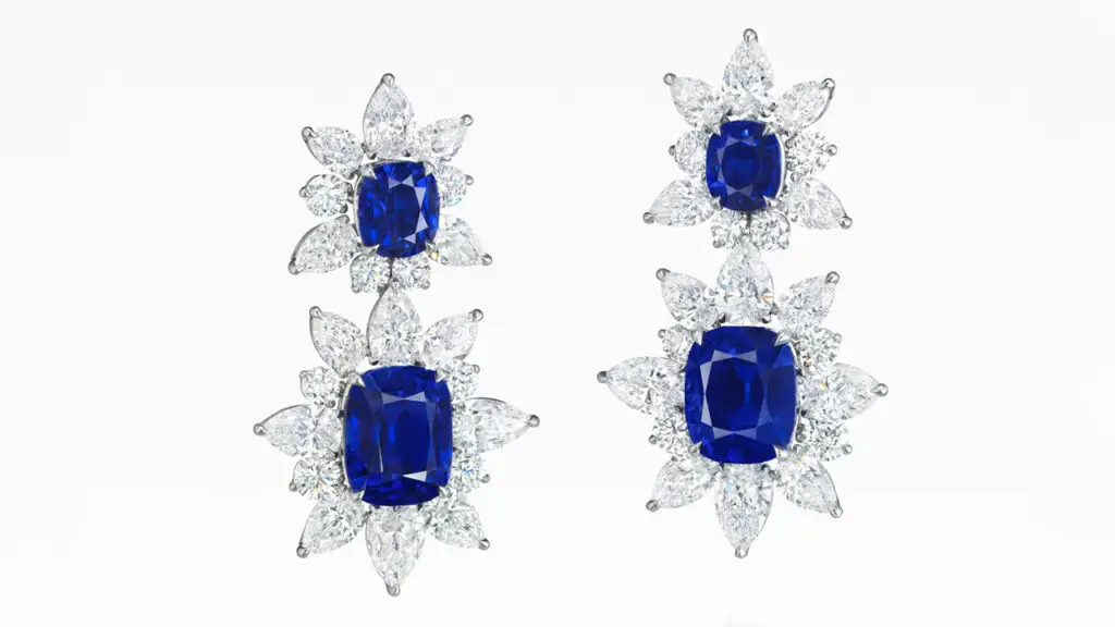 A pair of sapphire and diamond earrings features four cushion-shaped Kashmir sapphires weighing between 2.28 and 7.90 carats, in a frame of pear and round diamonds at Christie's image