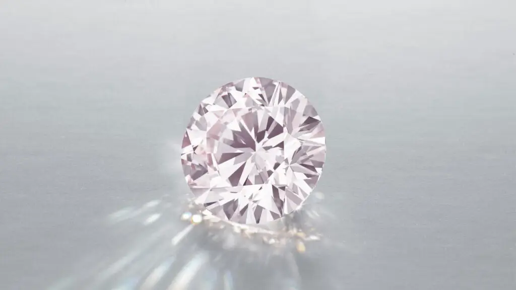 An unmounted round brilliant-cut, 12.86-carat, fancy-orangey-pink, VVS2 diamond at Christie's image