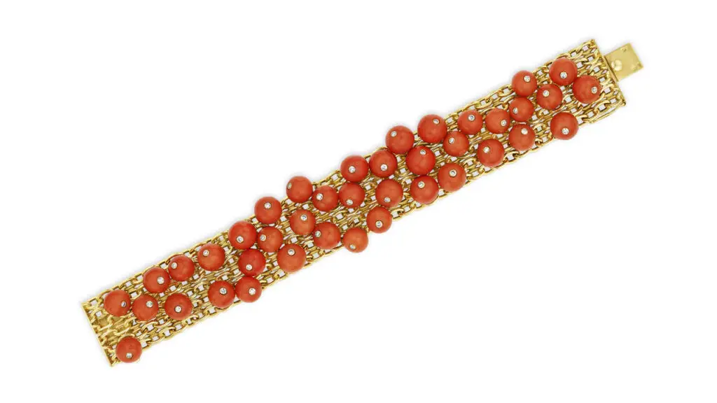 A Cartier gold bracelet with coral beads and single-cut diamonds at Christie's image