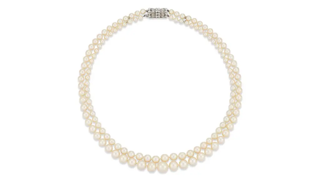 A necklace with 130 natural saltwater pearls in two graduating rows. Its claps bears single-cut diamonds at Christie's image