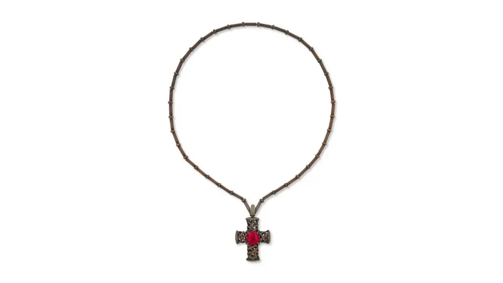 A Hemmerle necklace featuring a cushion-shaped, 10.25-carat Tanzanian red spinel in the center of a copper cross at Christie's image